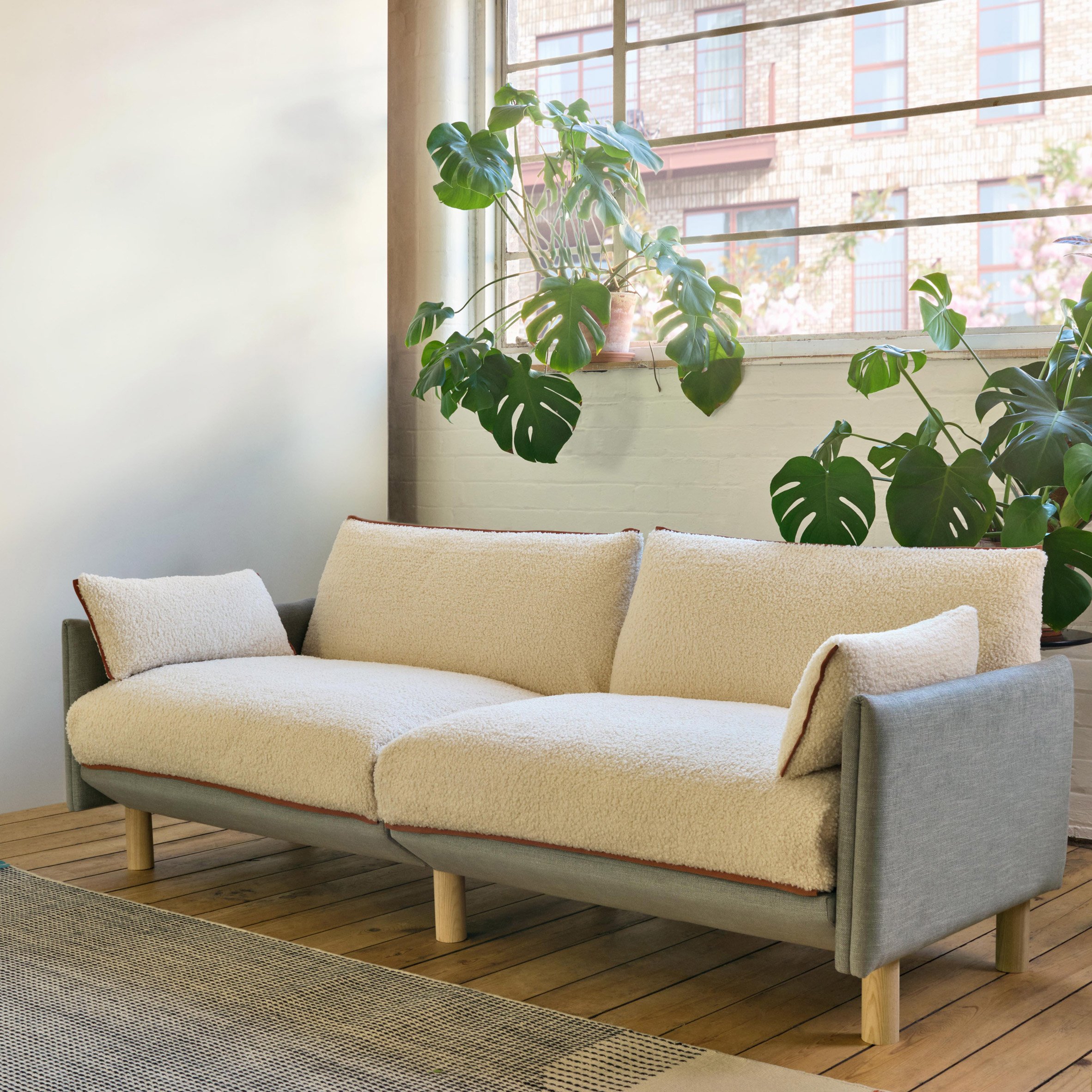 Sofa with white cover in room with plants