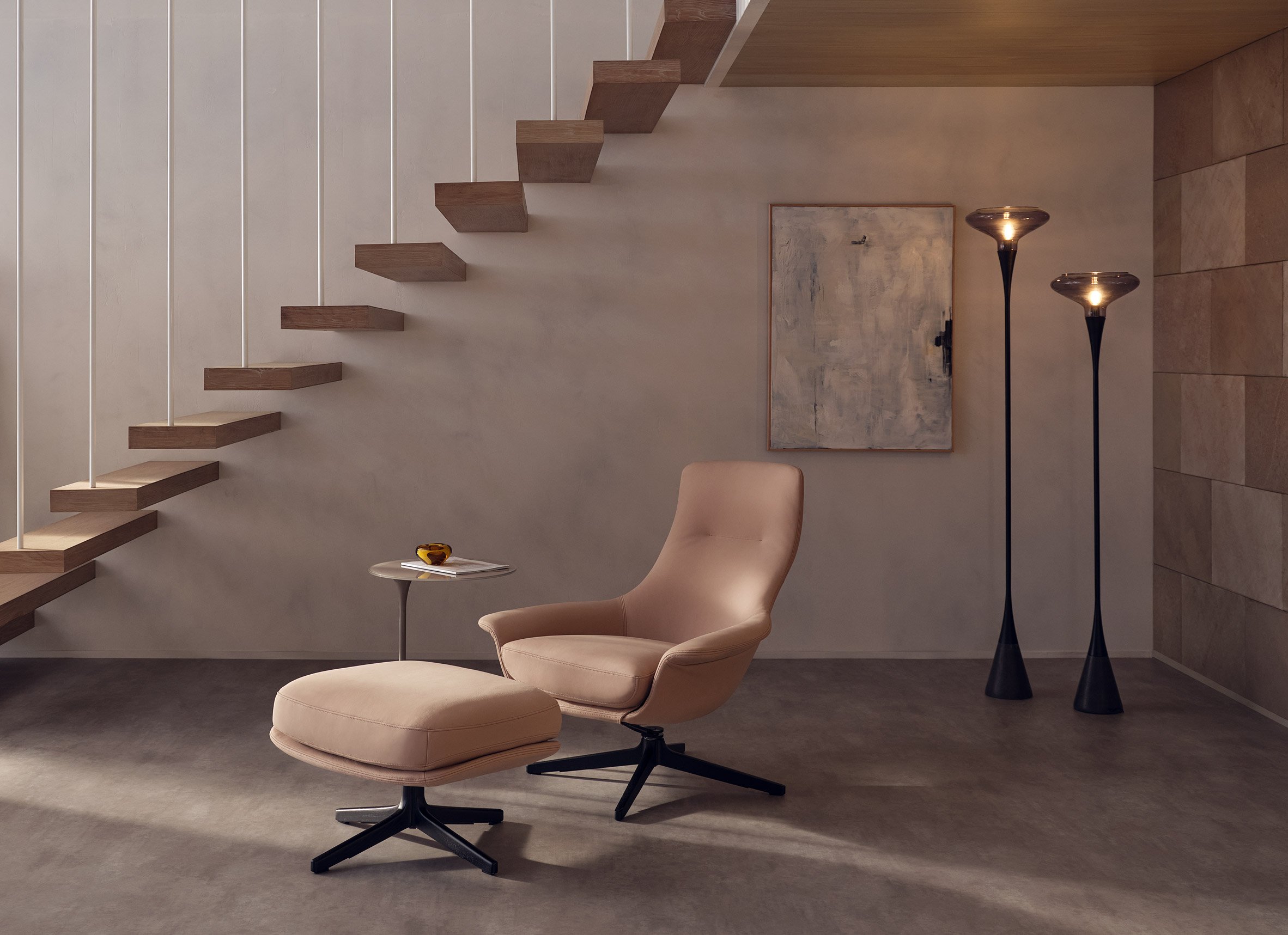 Chair and stool in room with stairs in background