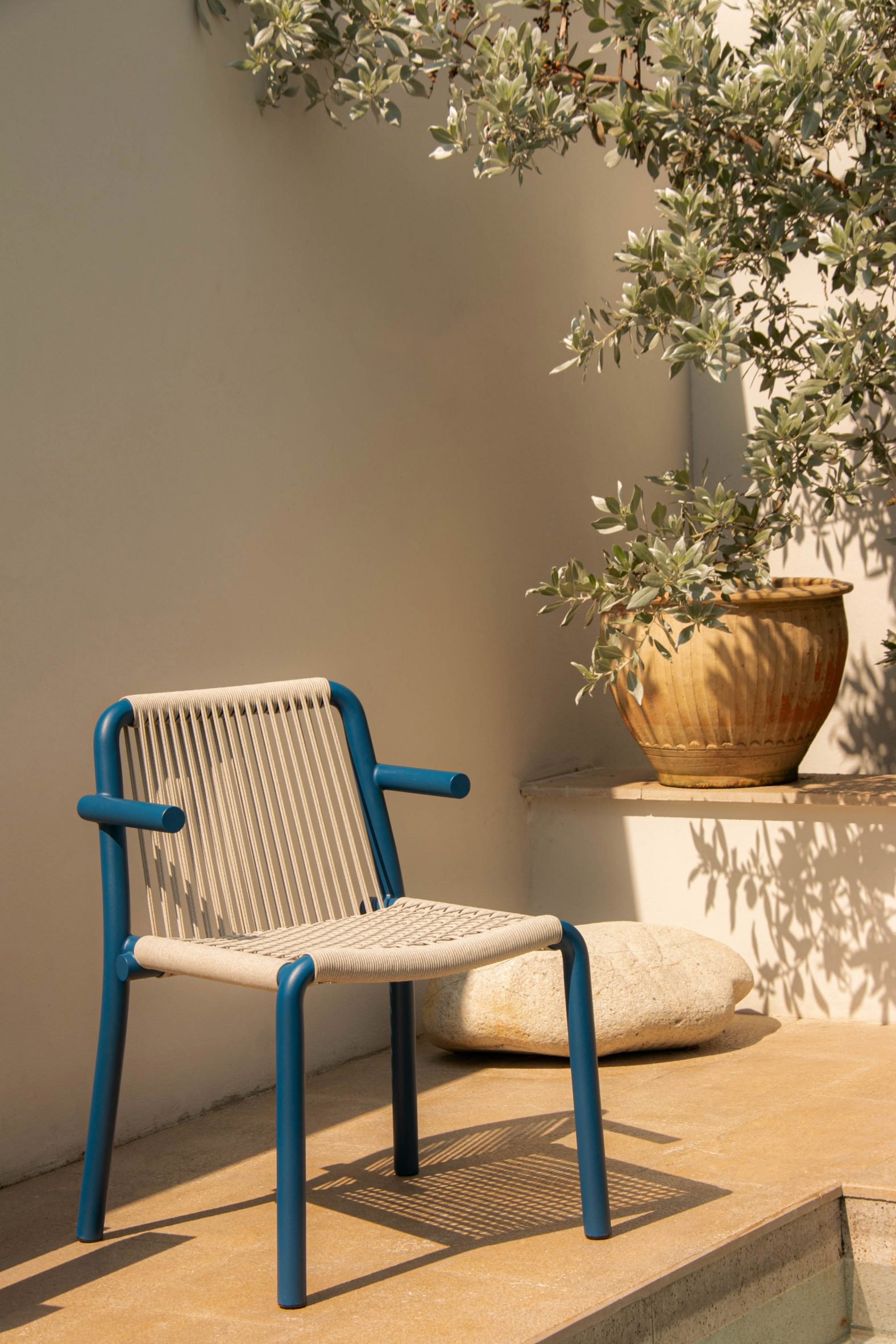 Photograph of blue and beige chair by pool