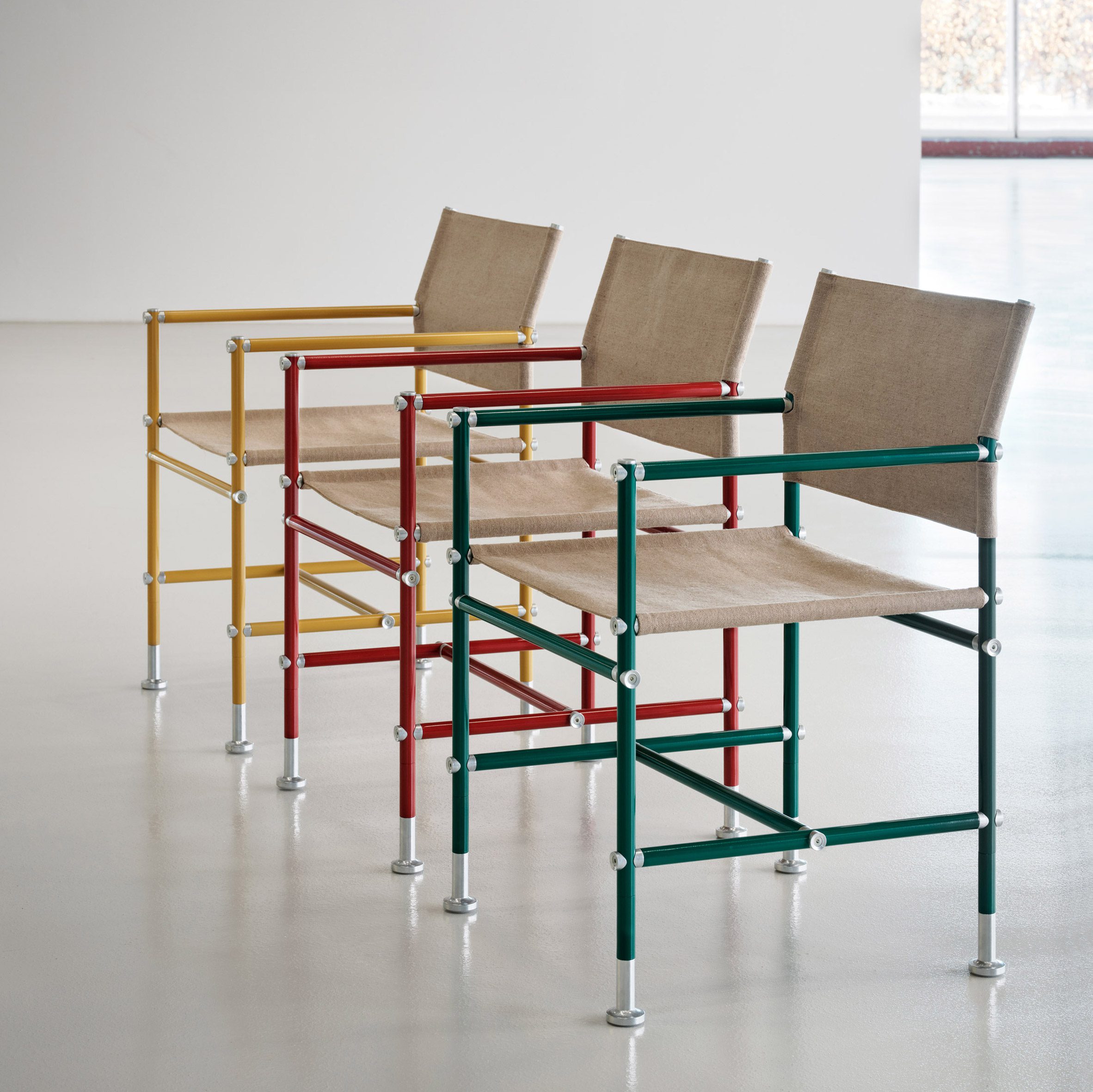 A line of three Able chairs by Blå Station with yellow, red and green frames