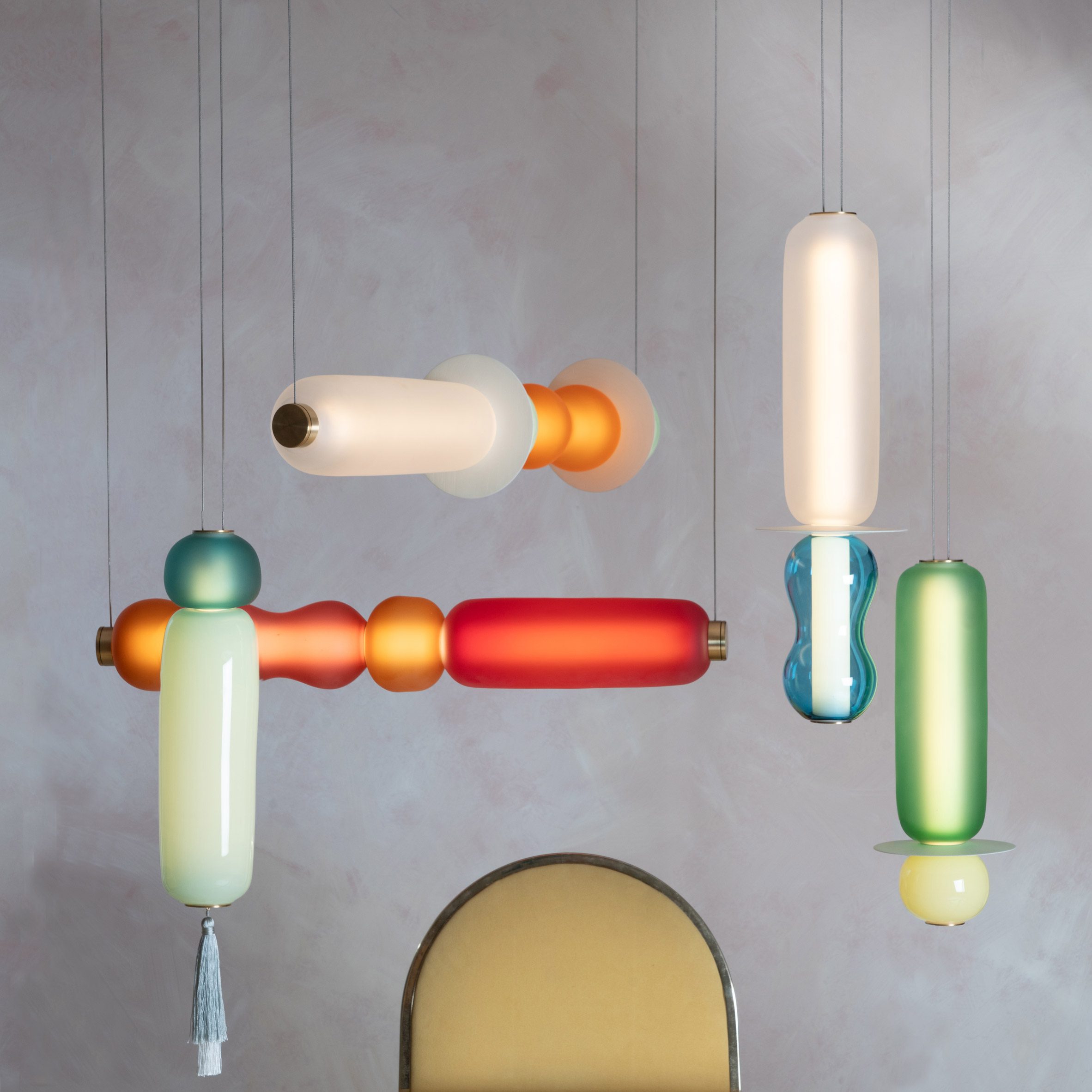 Photo of the Wave II pendant lights by Curiousa hanging above a table