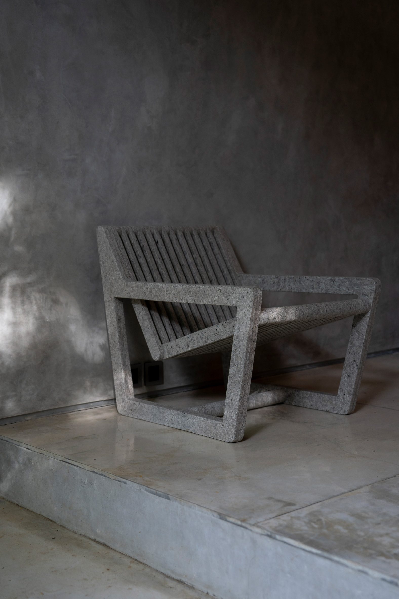 White chair by Sungai Design on a concrete backdrop