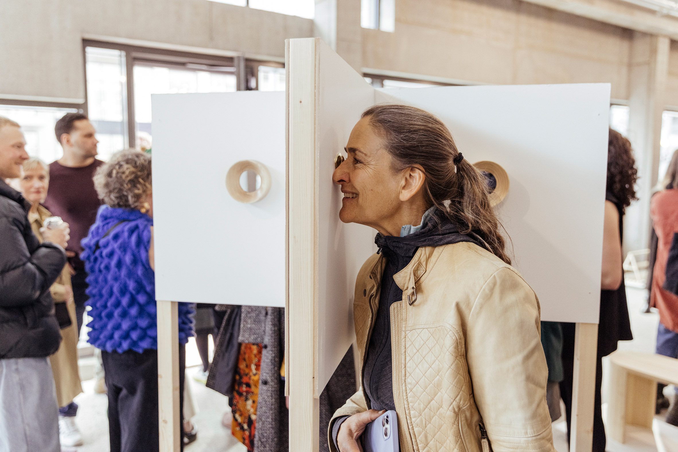 Woman looking through peephole by Fruitsuper at Hæ/Hi exhibition at DesignMarch