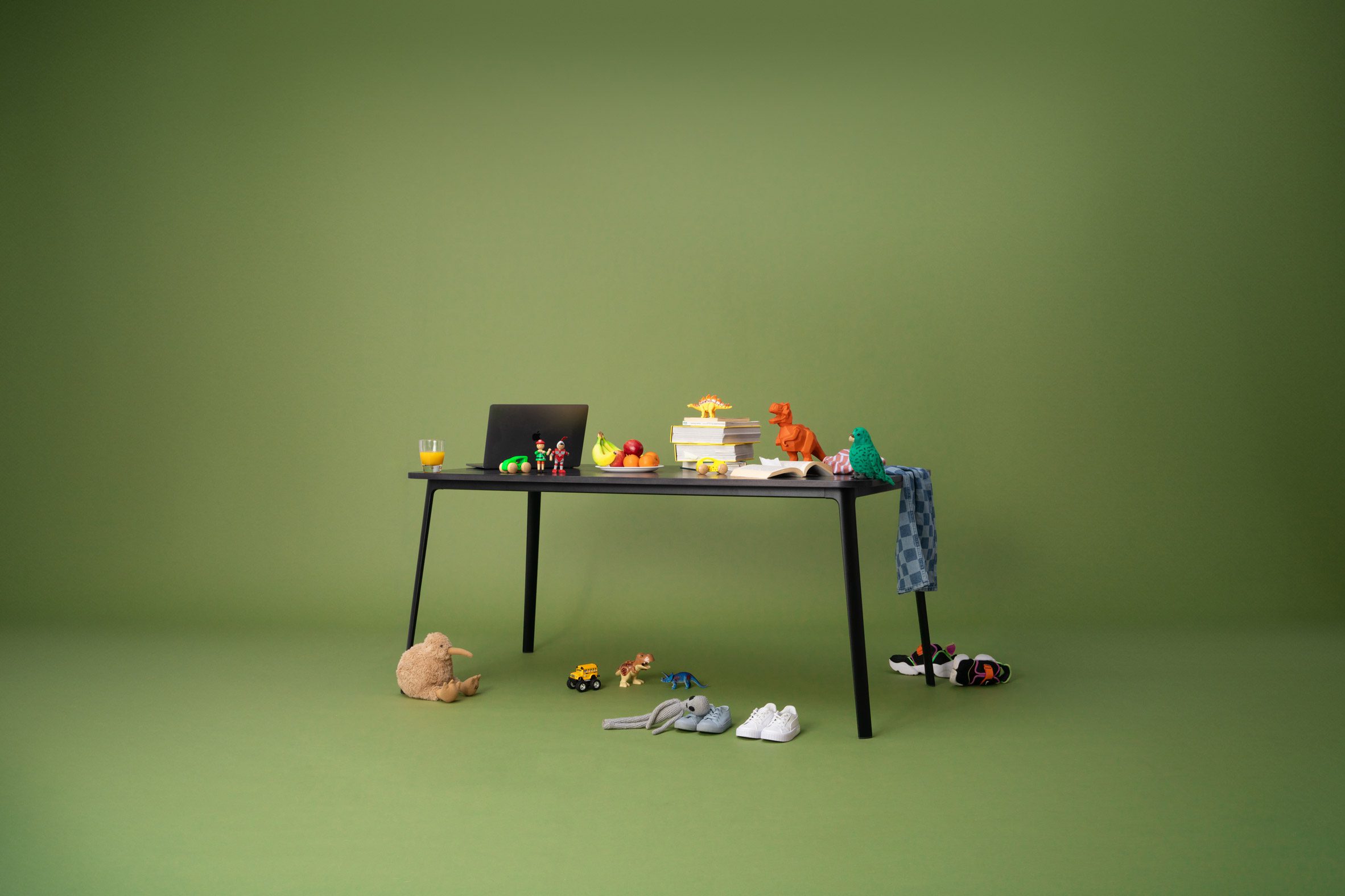 Table topped with a laptop and children's toys