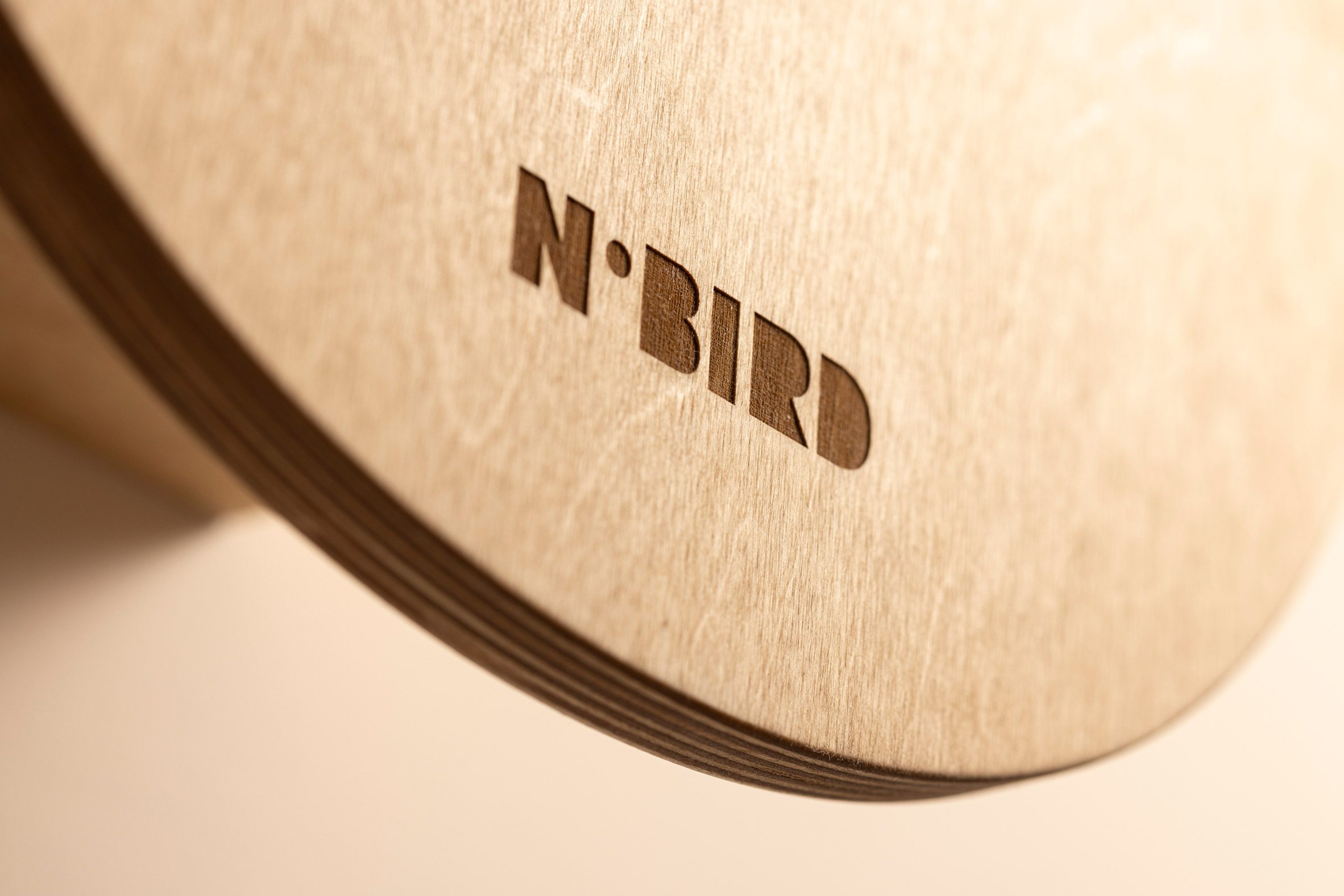 A close up photograph of wood with the word 'nobird' etched out in a darker colour.