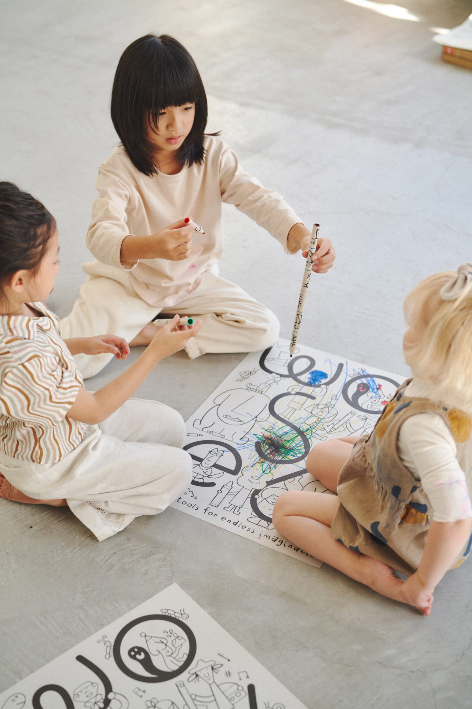 Three girls playing with snap-and-share markers