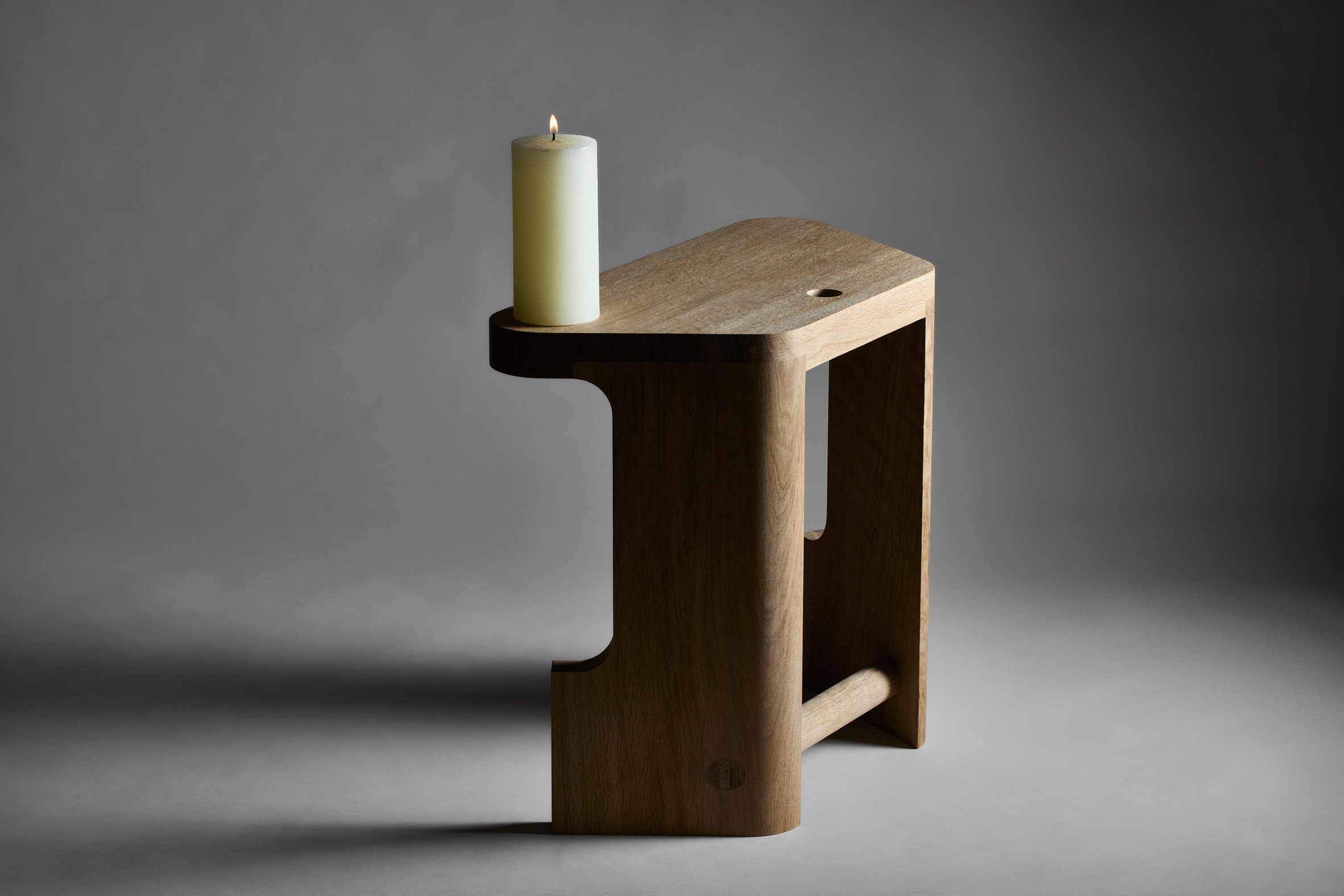 Pew stool by EJM Studio with candle on top