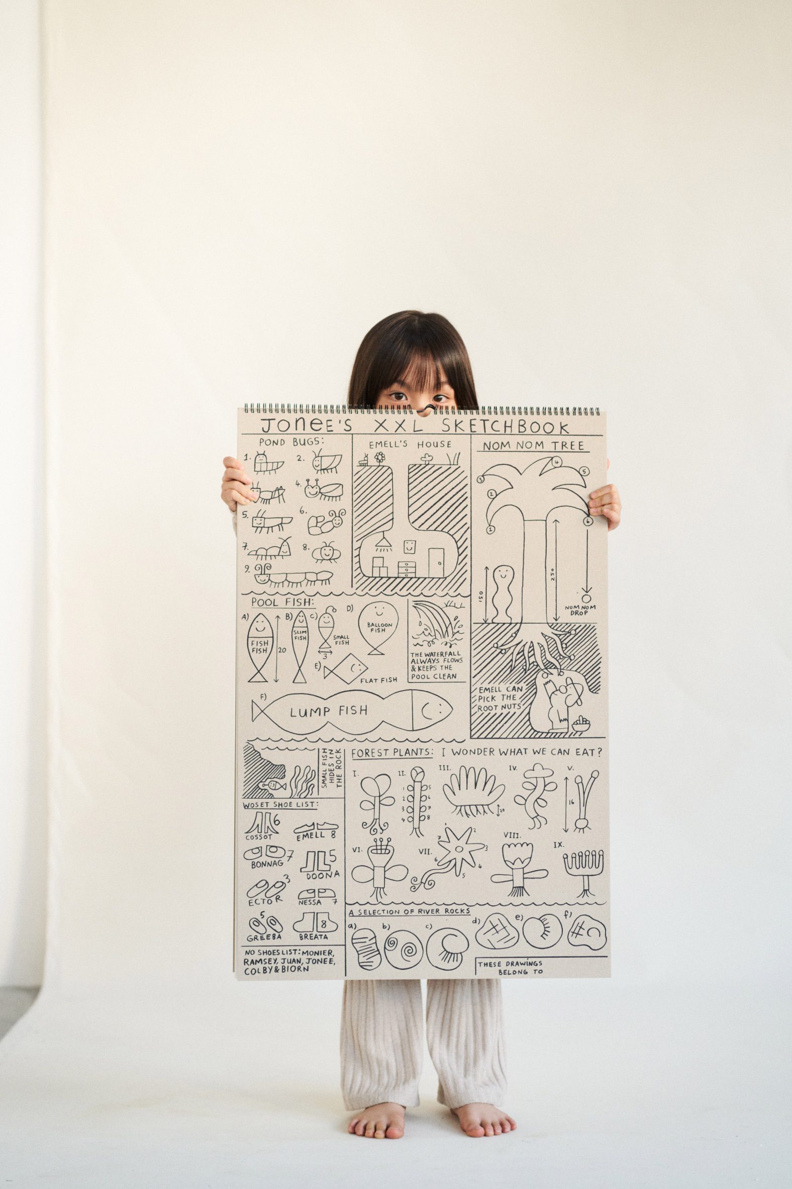 Girl holding Giant XXL sketchbook by Woset