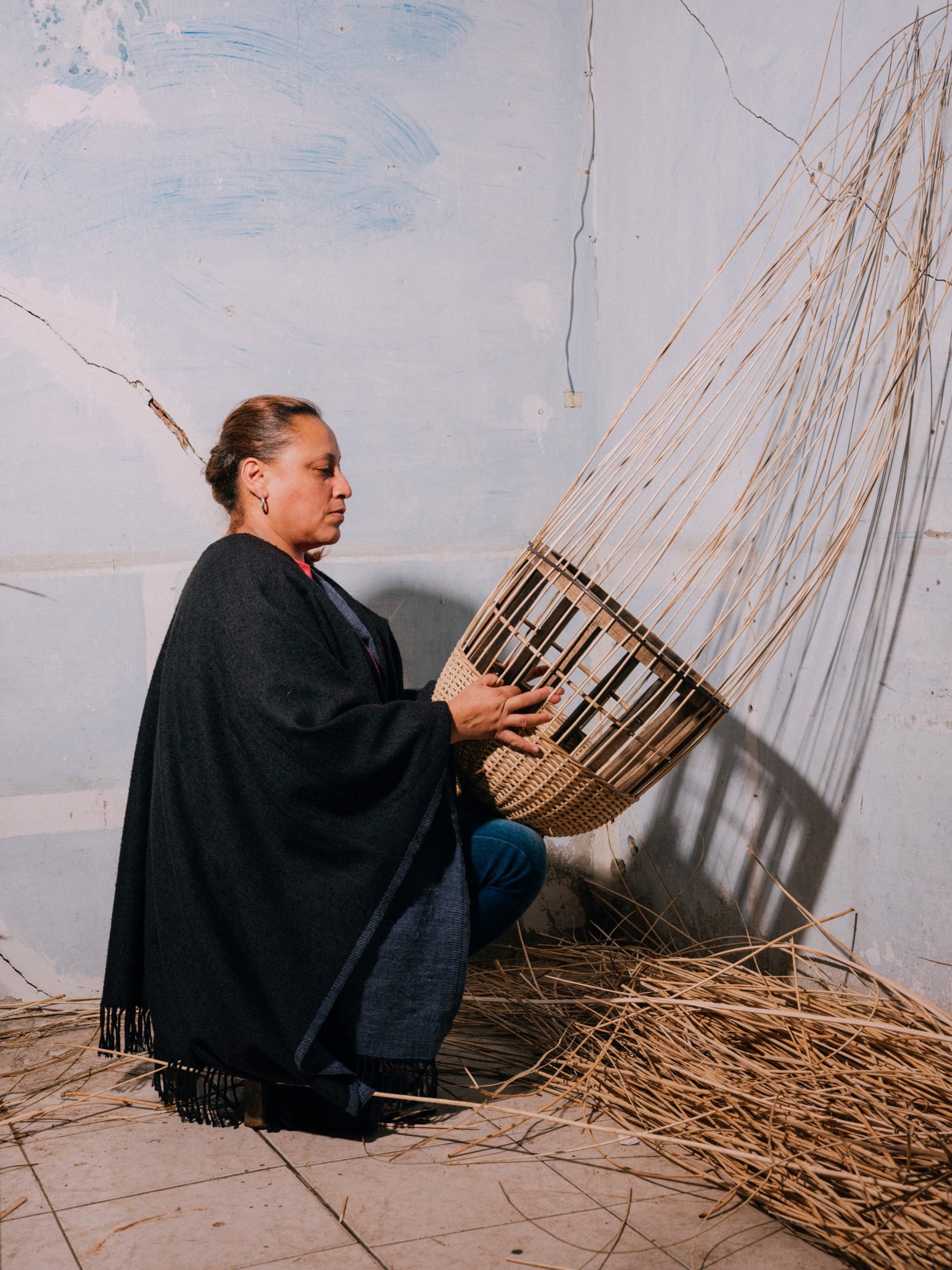 Photograph of a local artisan weaving yaré in the studio.