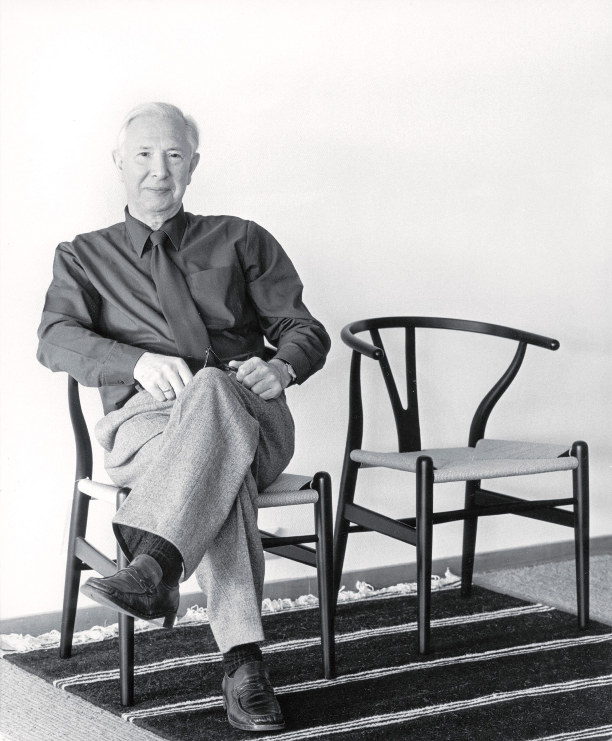 Hans J Wegner on a CH24 Wishbone Chair